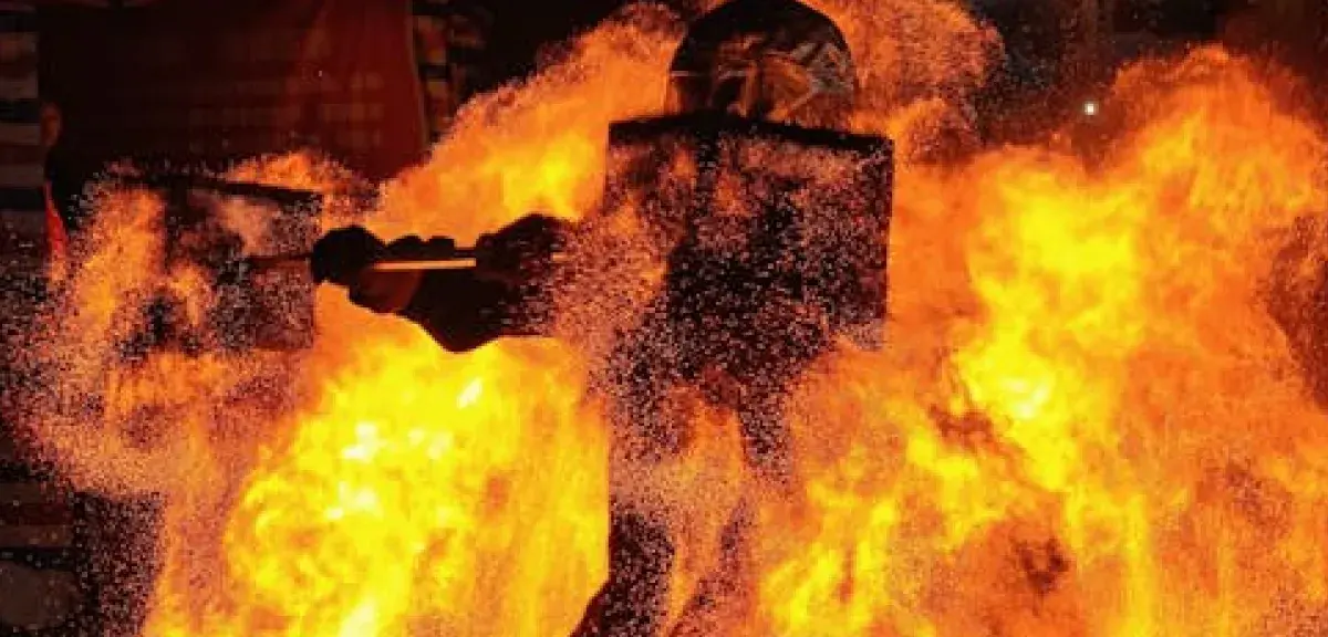 Intense fire performer creating a dramatic spectacle with bright flames.