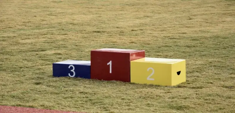 a group of colorful boxes on a grass field