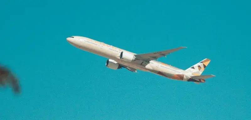 white airplane flying in the sky during daytime