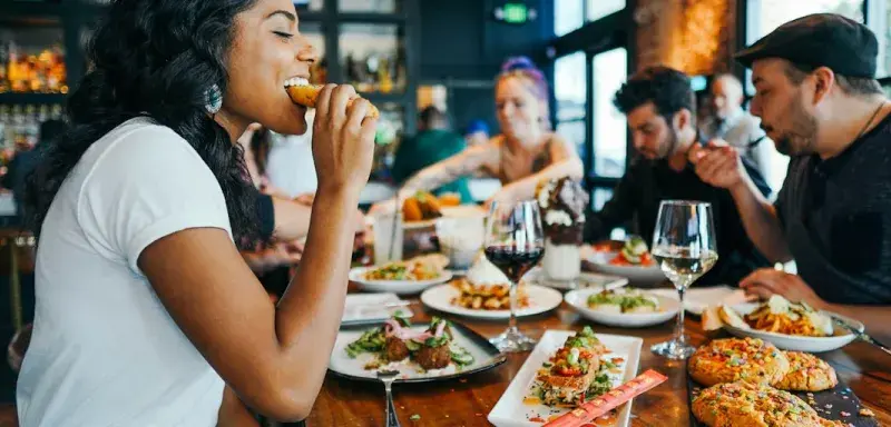 woman in white shirt eating