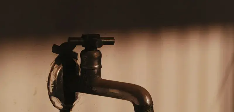 a faucet that is sitting on a wall