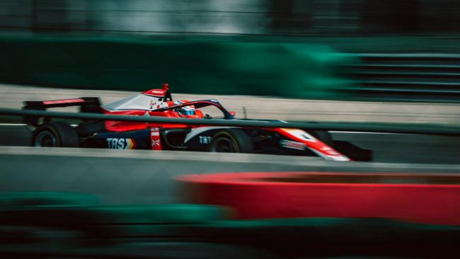 Un pilote au volant d'une voiture de course sur un circuit