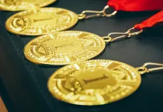 Des médailles d or alignées avec un ruban rouge, symboles de la gloire olympique