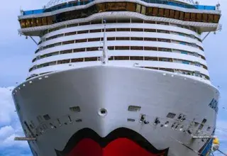 Front view of a large cruise ship docked at the port of Ajaccio, Corsica.