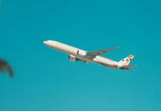 white airplane flying in the sky during daytime