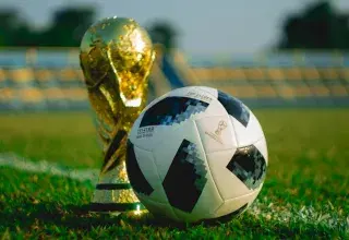 Ballon de football et trophée sur un terrain, illustration Coupe du monde
