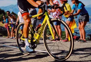 man riding yellow bicycle