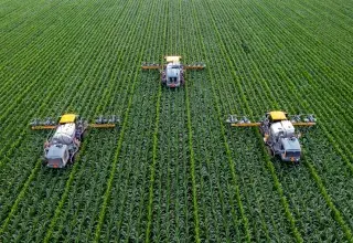 yellow and black heavy equipment on green field during daytime