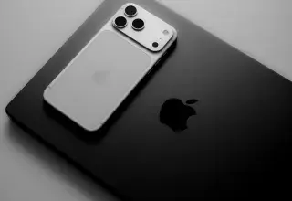 Silver smartphone resting on a black laptop