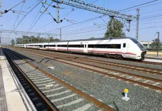 High-speed train at Jerez de la Frontera railway station, sunny day.